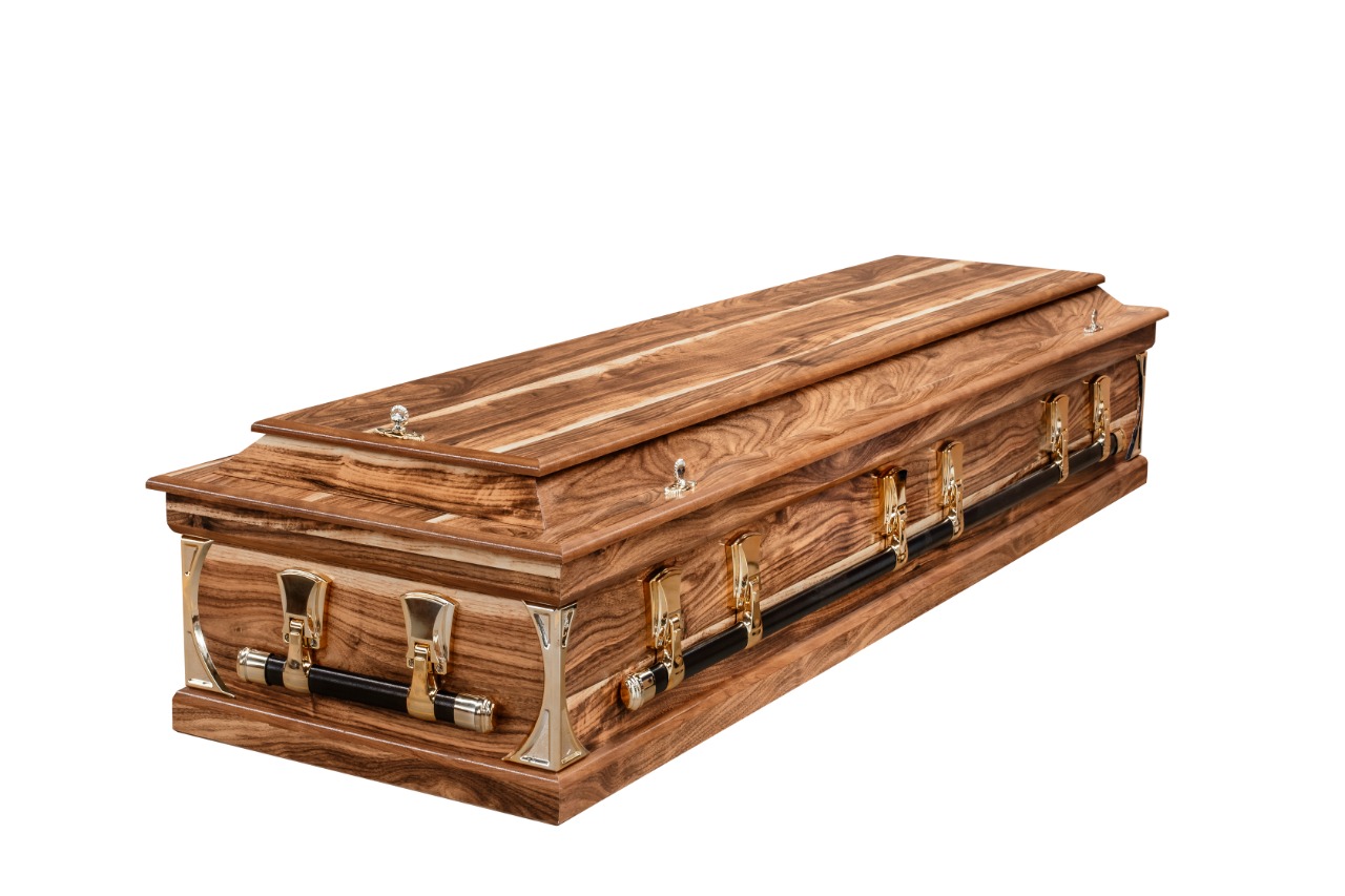 Walnut-finish coffin with gold-tone corner posts, closed lid
