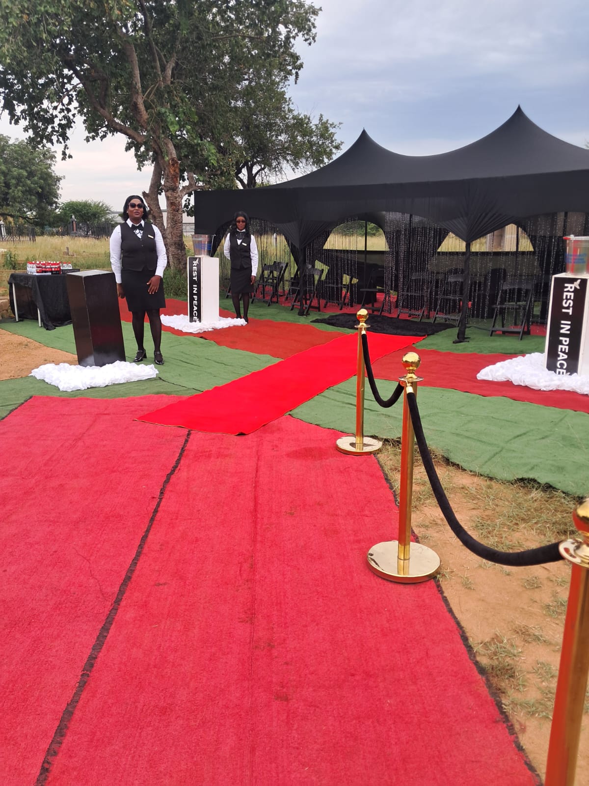 Graveside tent and red carpet aisle, alternate view